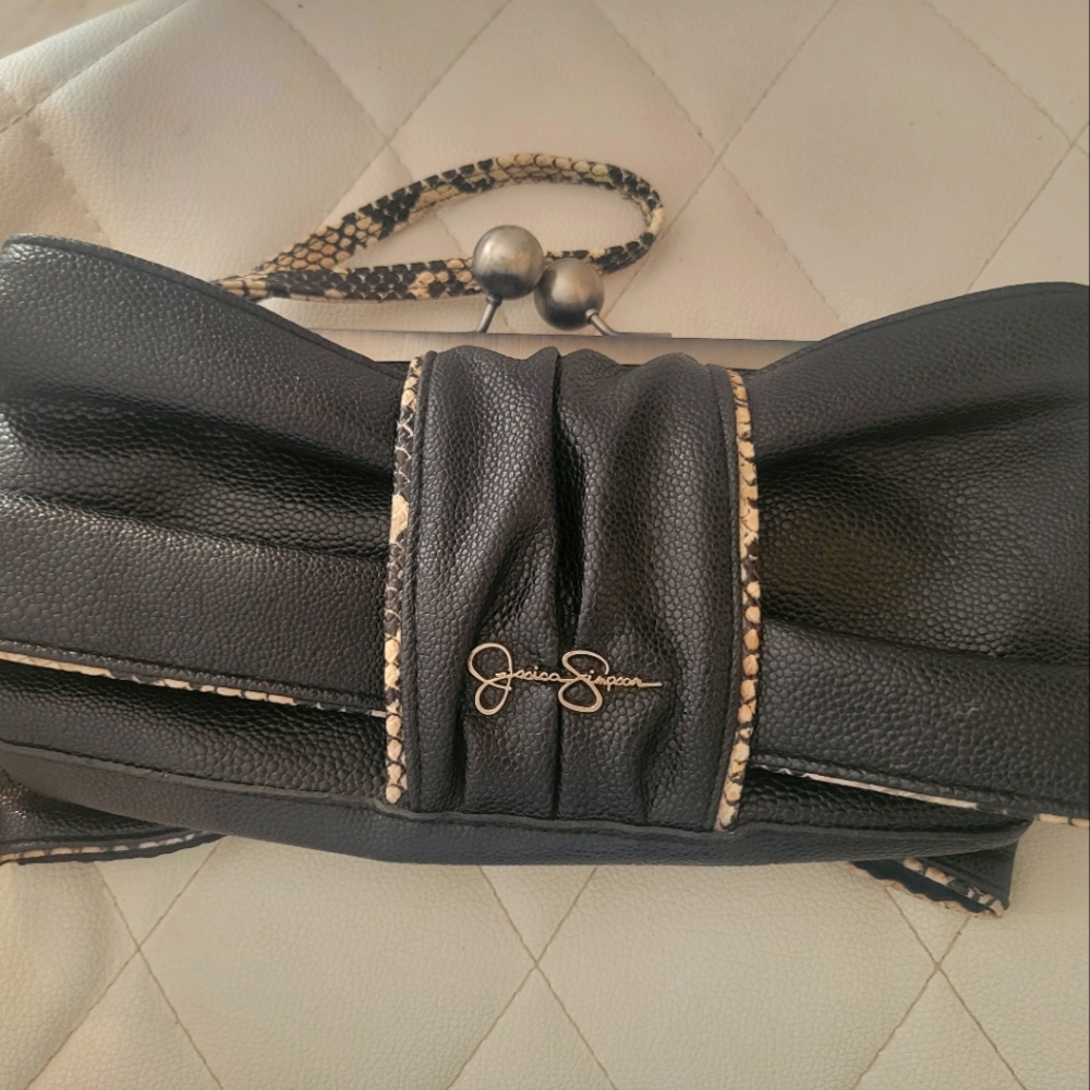 Small leather clutch sophisticated black purse with wristlet and brown accents